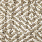 Close-up of a textured natural fibre woven diamond pattern rug in beige. 