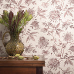 Floral wallpaper with a vase and plant on a wooden surface