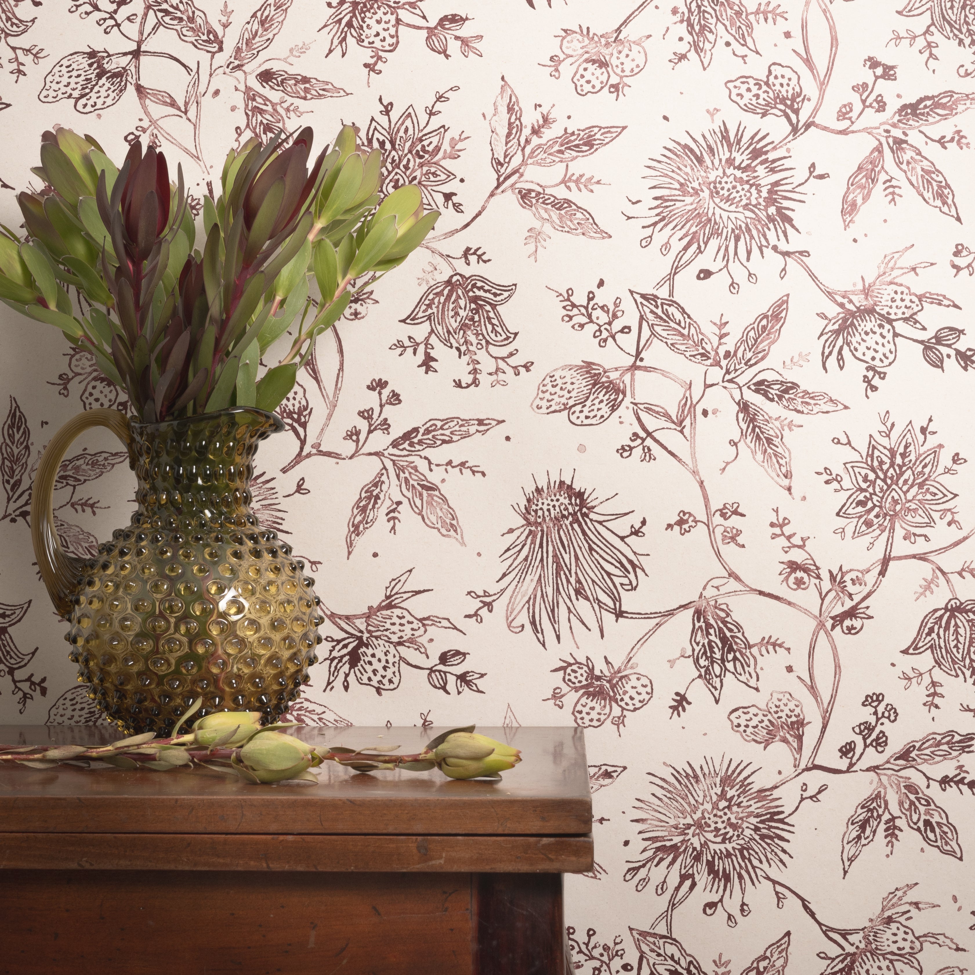 Floral wallpaper with a vase and plant on a wooden surface