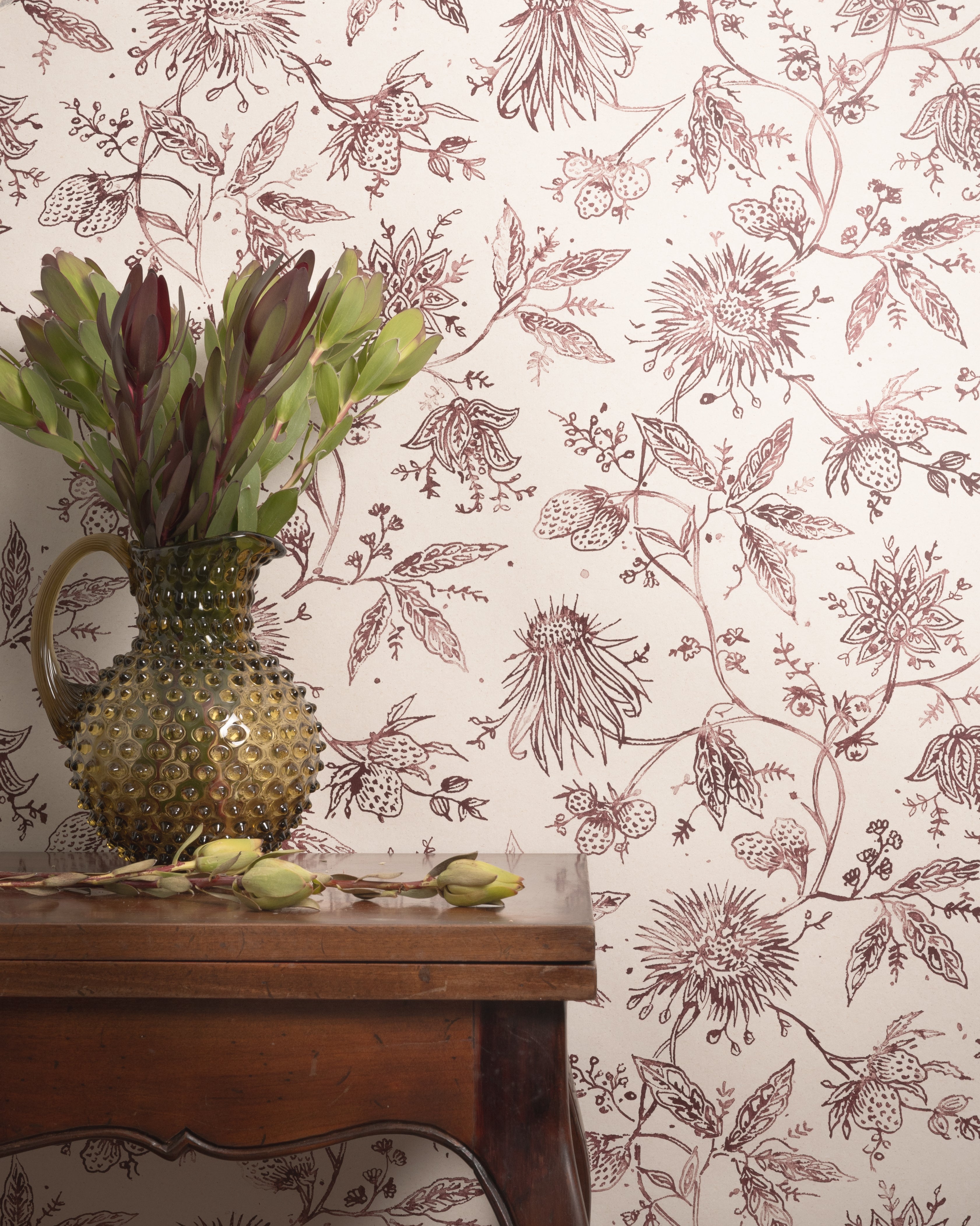Floral wallpaper with a vase and plant on a wooden surface