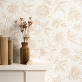 Mantle with books and flower vase against watercolor floral wallpaper. 