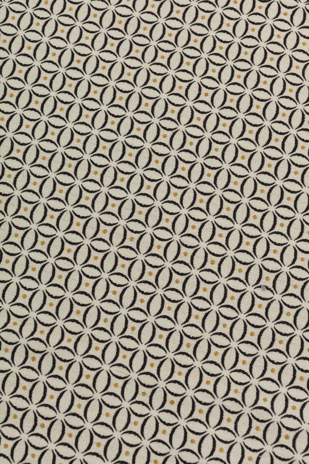 Detail of woven fabric in a geometric grid print in yellow and brown on a cream field.