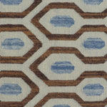Close-up of a patterned rug with blue and brown geometric design