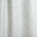 Draped fabric with small scale coral design in light blue on white. 