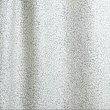 Draped fabric with small scale coral design in light blue on white. 