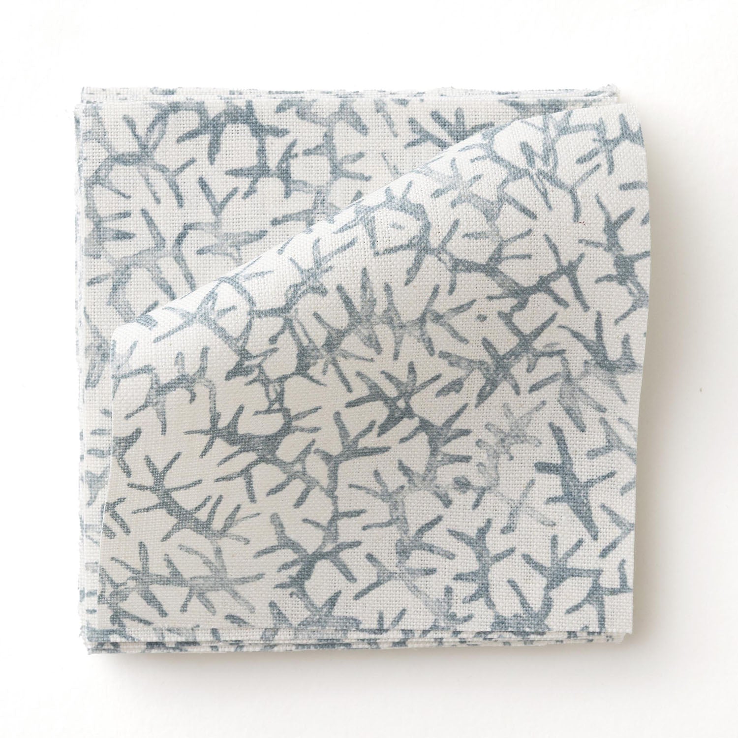 Fabric swatch with a blue coral pattern on a white background