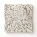 Fabric swatch with a grey coral pattern on a white background