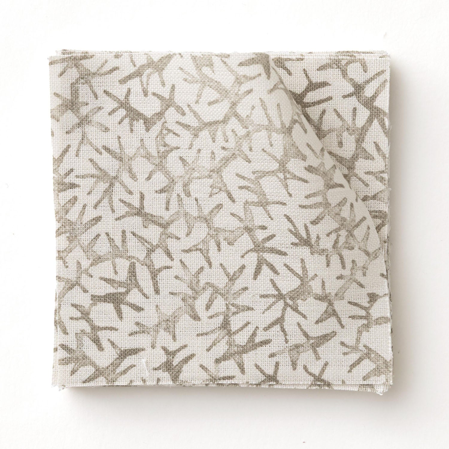 Fabric swatch with a grey coral pattern on a white background