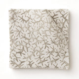 Fabric swatch with a grey coral pattern on a white background