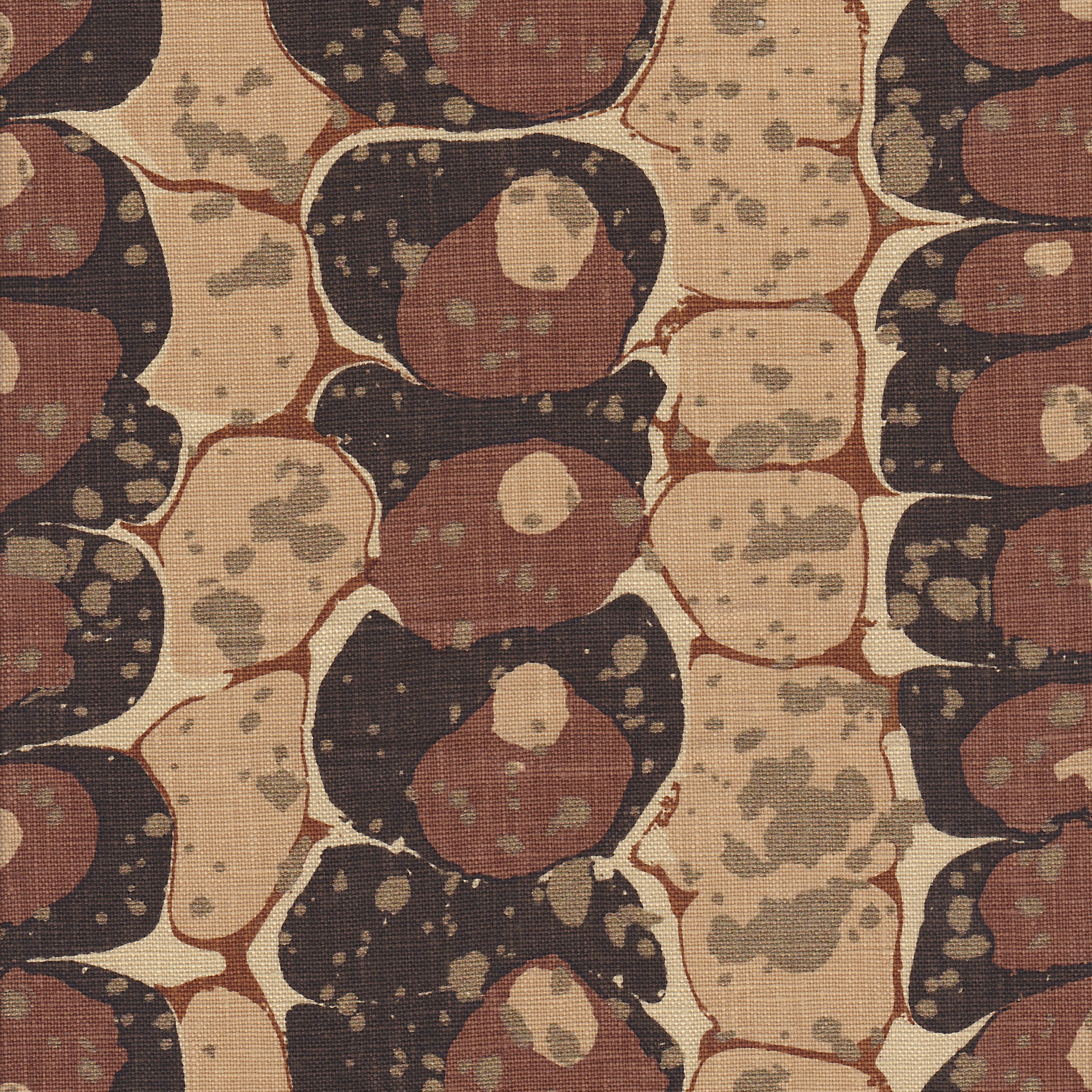 Detail of fabric in a marbled paint print in shades of brown, tan and black.