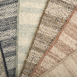 Close-up of various textured rug samples.