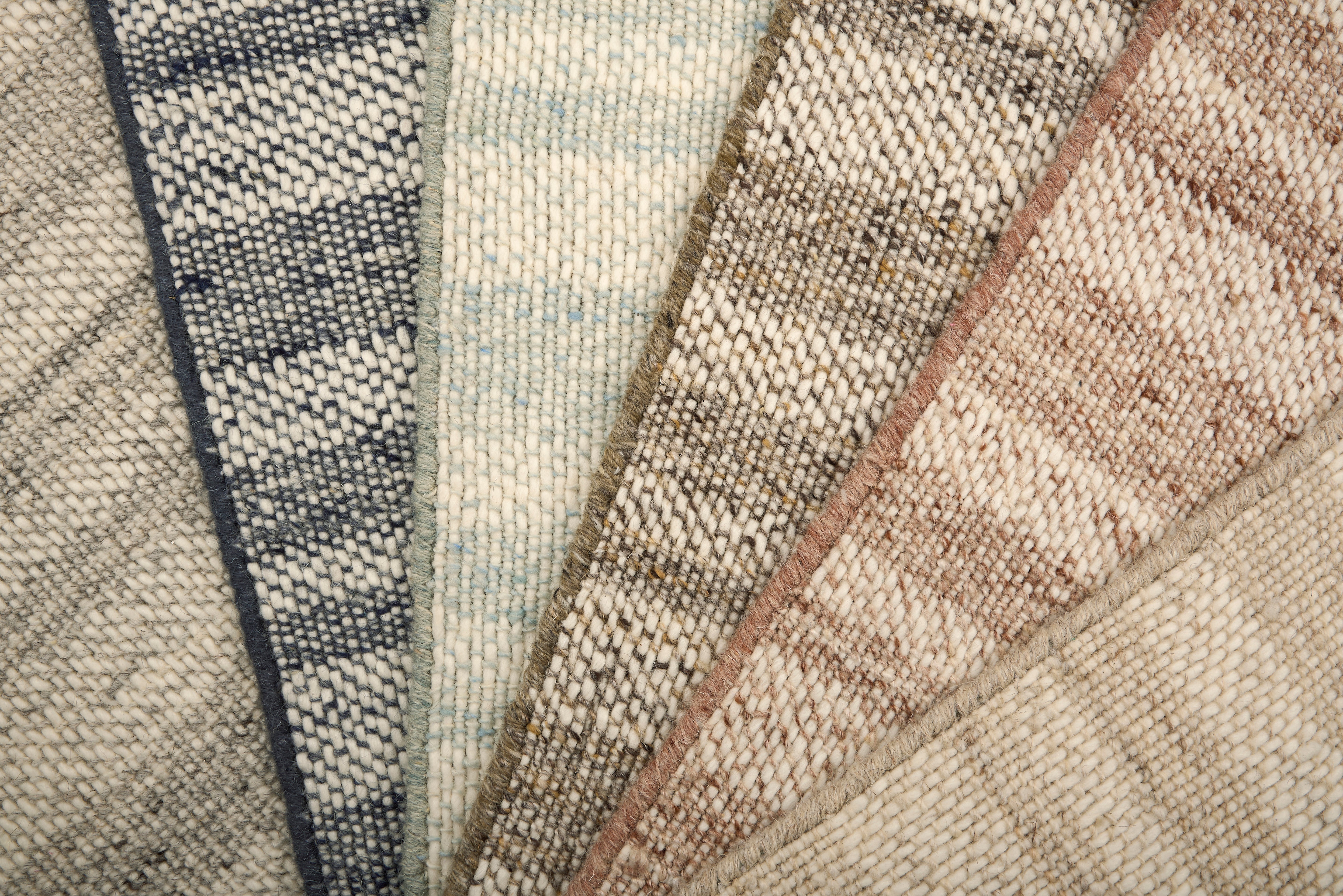 Close-up of various textured rug samples.