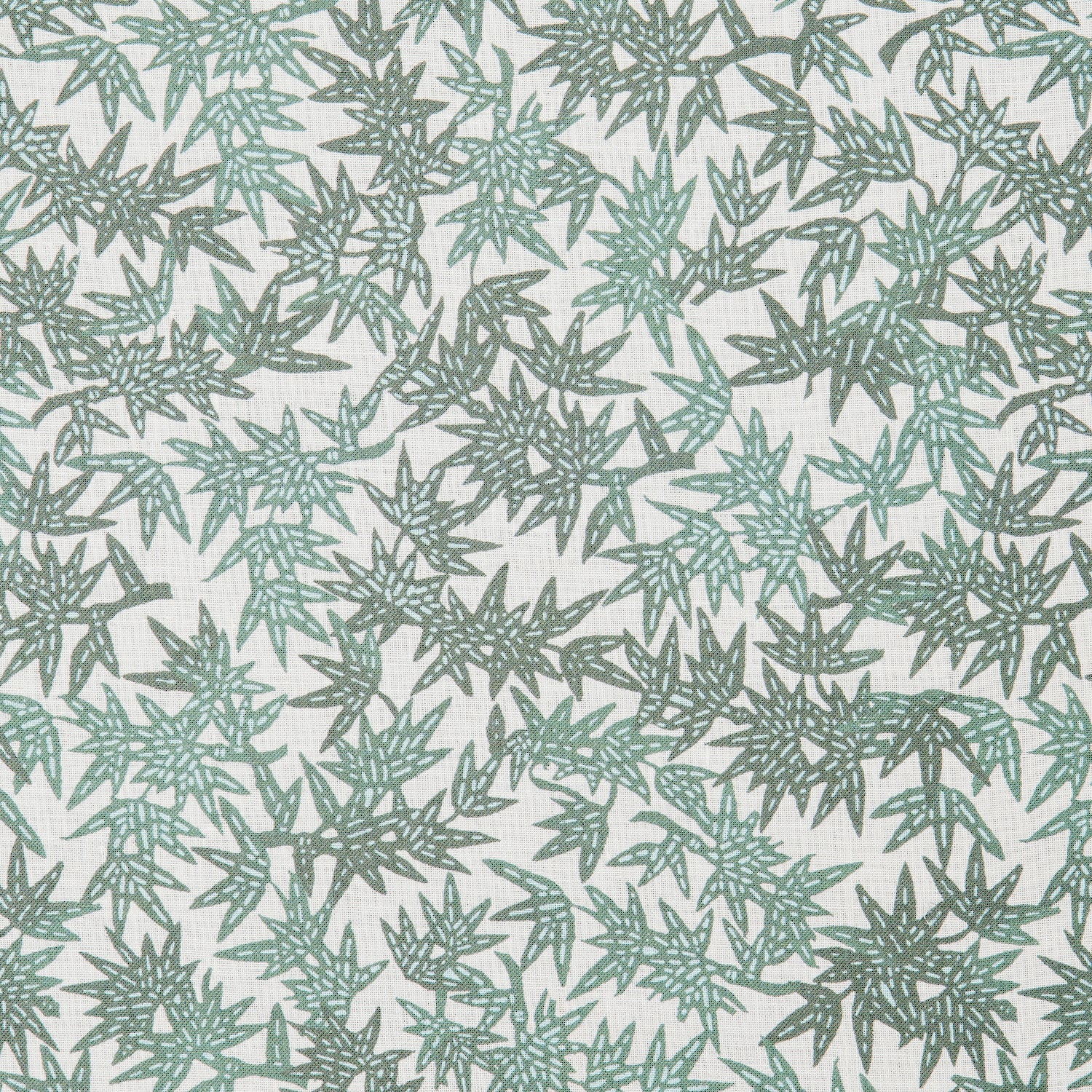 Detail of a printed linen fabric in a repeating bamboo leaf pattern in shades of green on a white field.
