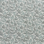 Printed linen fabric in a repeating bamboo leaf pattern in shades of green on a white field.