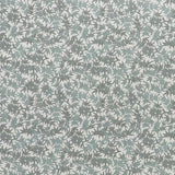 Printed linen fabric in a repeating bamboo leaf pattern in shades of green on a white field.