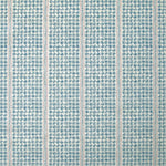 Detail of fabric in a dense repeating stripe and star print in blue on a cream field.