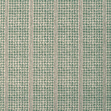 Detail of fabric in a dense repeating stripe and star print in green on a tan field.