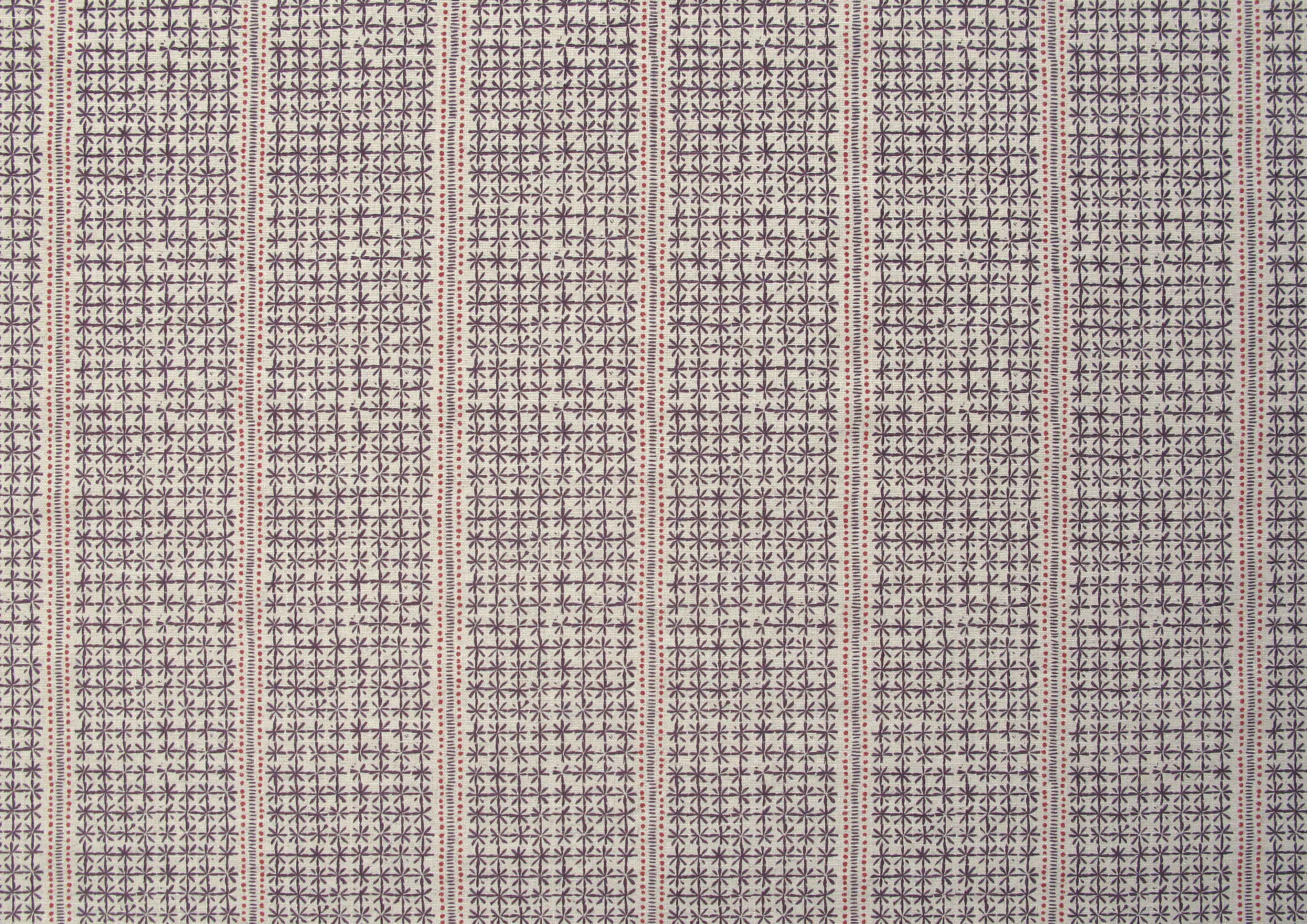 Detail of fabric in a dense repeating stripe and star print in purple on a tan field.