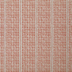 Detail of fabric in a dense repeating stripe and star print in red on a cream field.