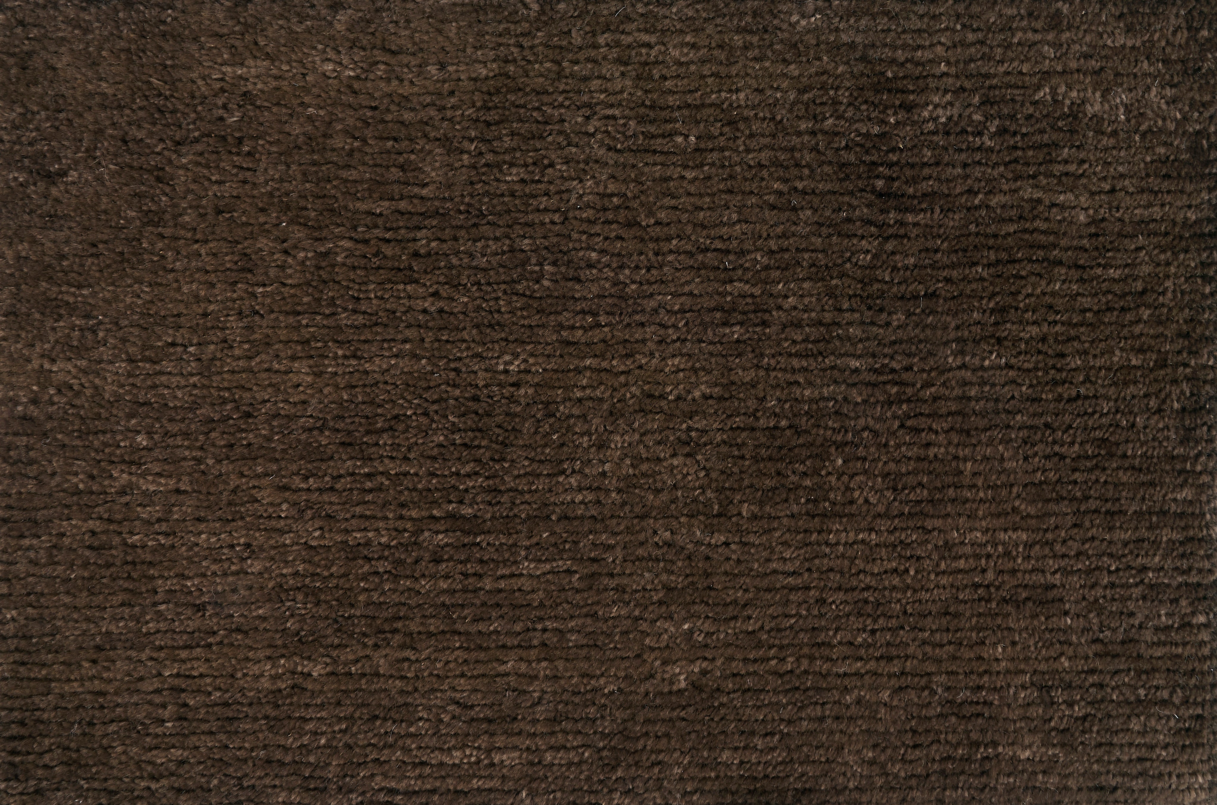 Broadloom carpet solid ribbed cut pile in dark brown.