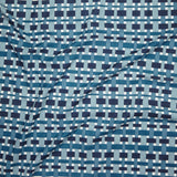 Close up of printed linen with graphic plaid pattern in shades of light blue, denim and navy blue.