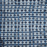Close up of gently draped woven Indoor-Outdoor fabric with graphic plaid pattern in shades of light and dark blue with white. 