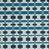 Close up of wallpaper with graphic plaid pattern in shades of light blue, denim and navy blue.