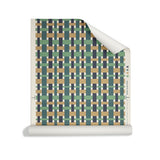 Roll of wallpaper with graphic plaid pattern in green, navy blue and tan on a white background. 