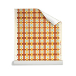 Roll of wallpaper with graphic plaid pattern in red, orange, yellow and aqua blue on a white background. 