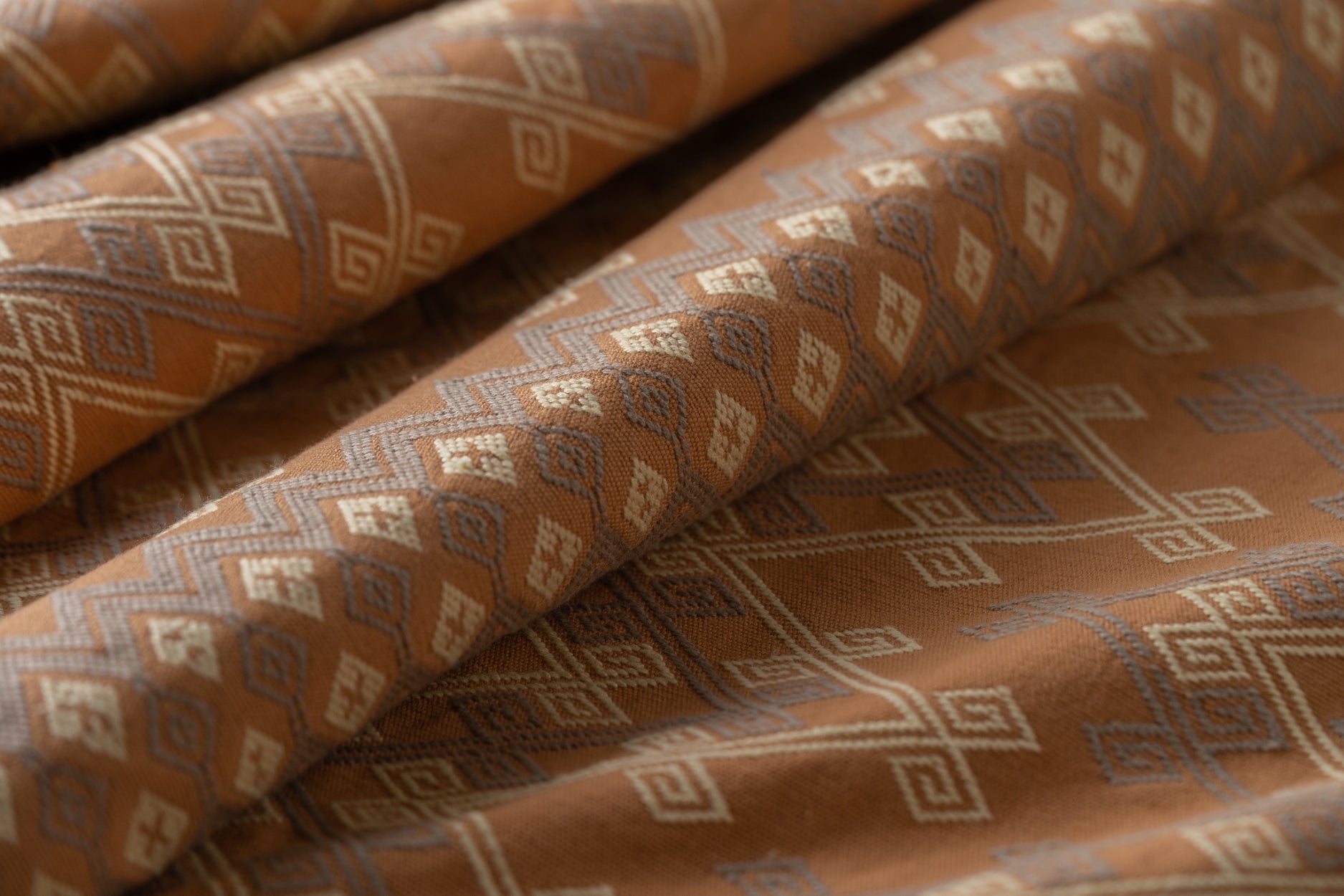Patterned fabric with geometric design in brown and beige tones
