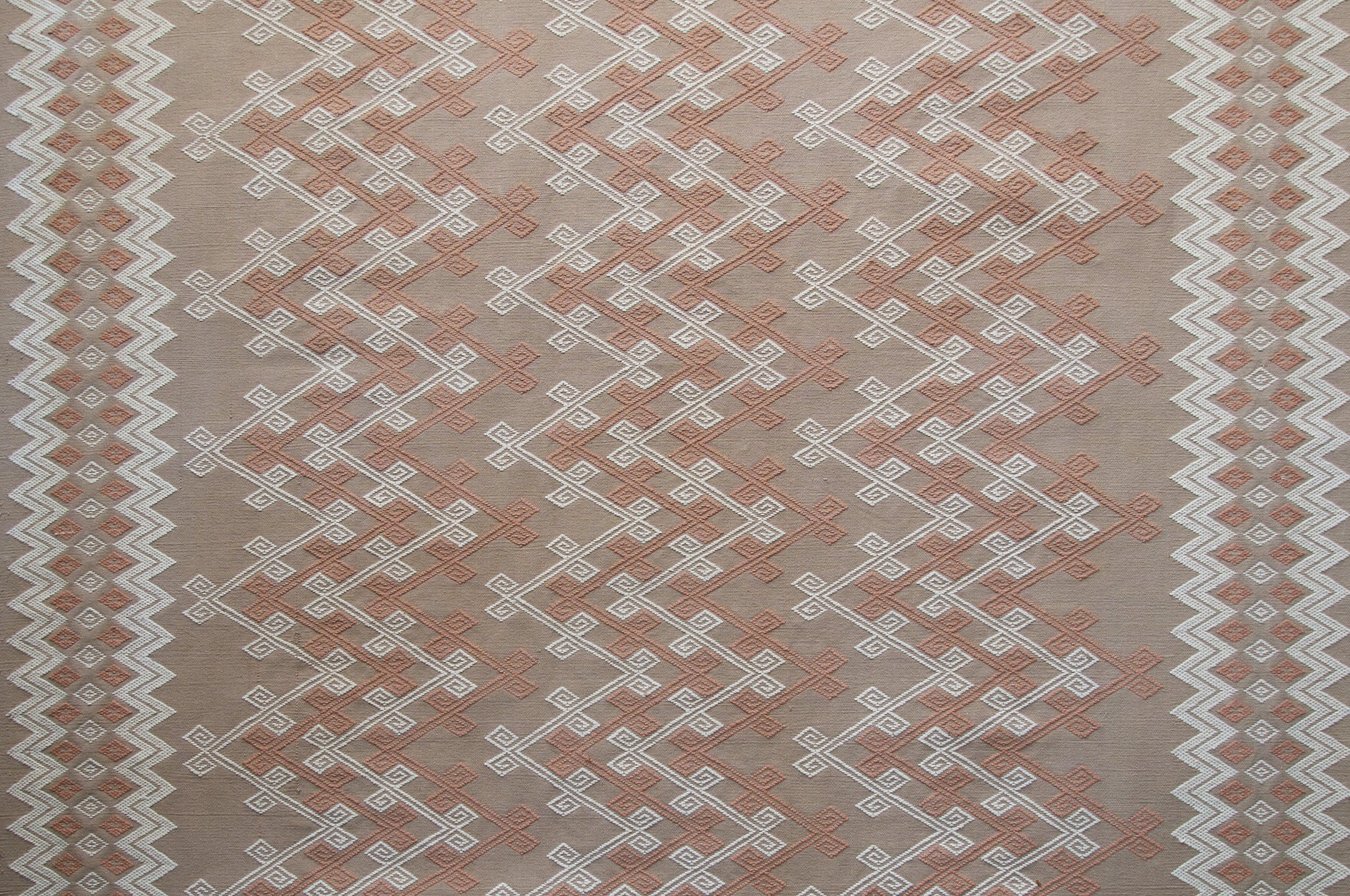 Textile with a geometric pattern on a beige background