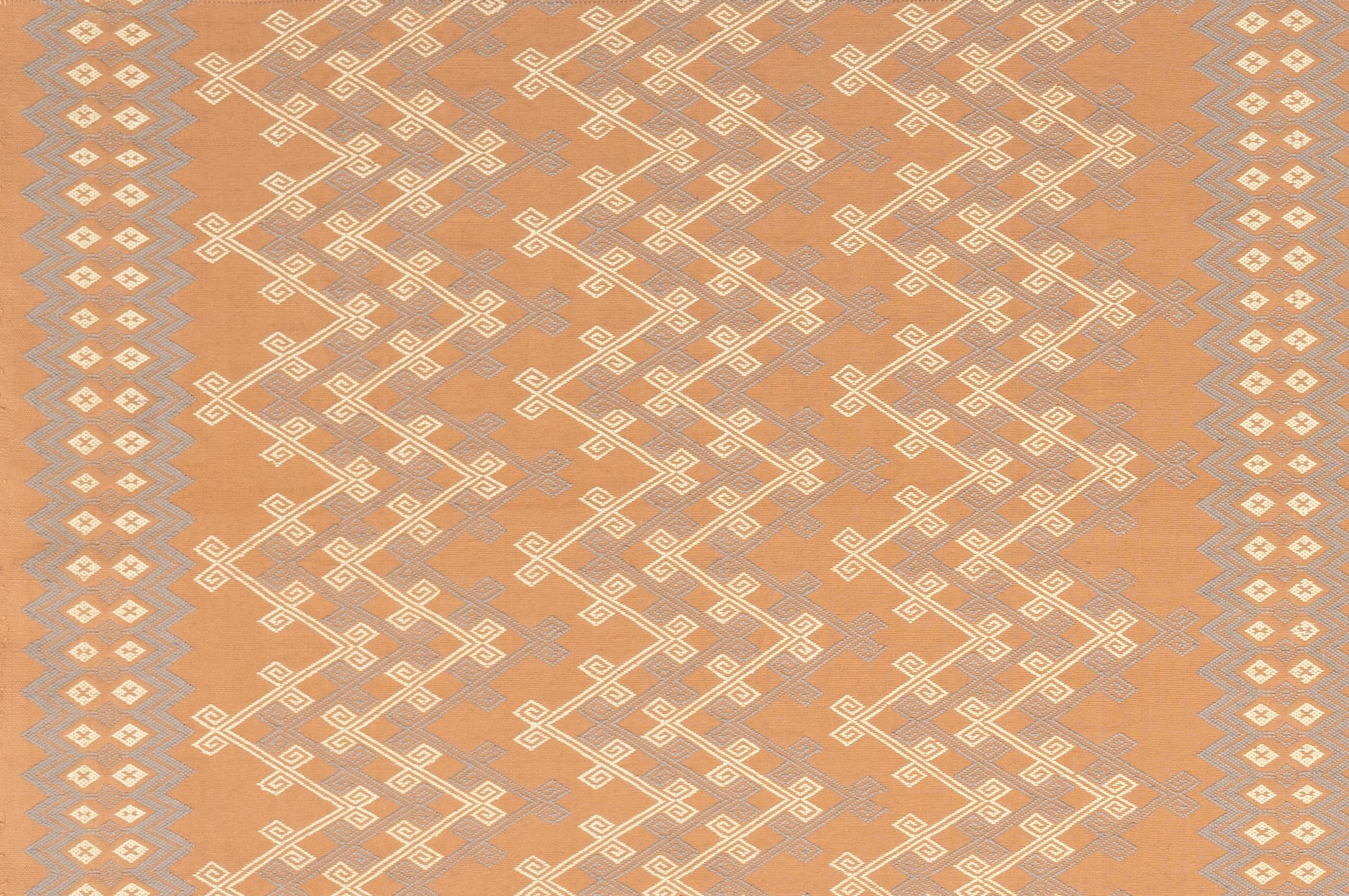 Patterned fabric with geometric design on a tan background