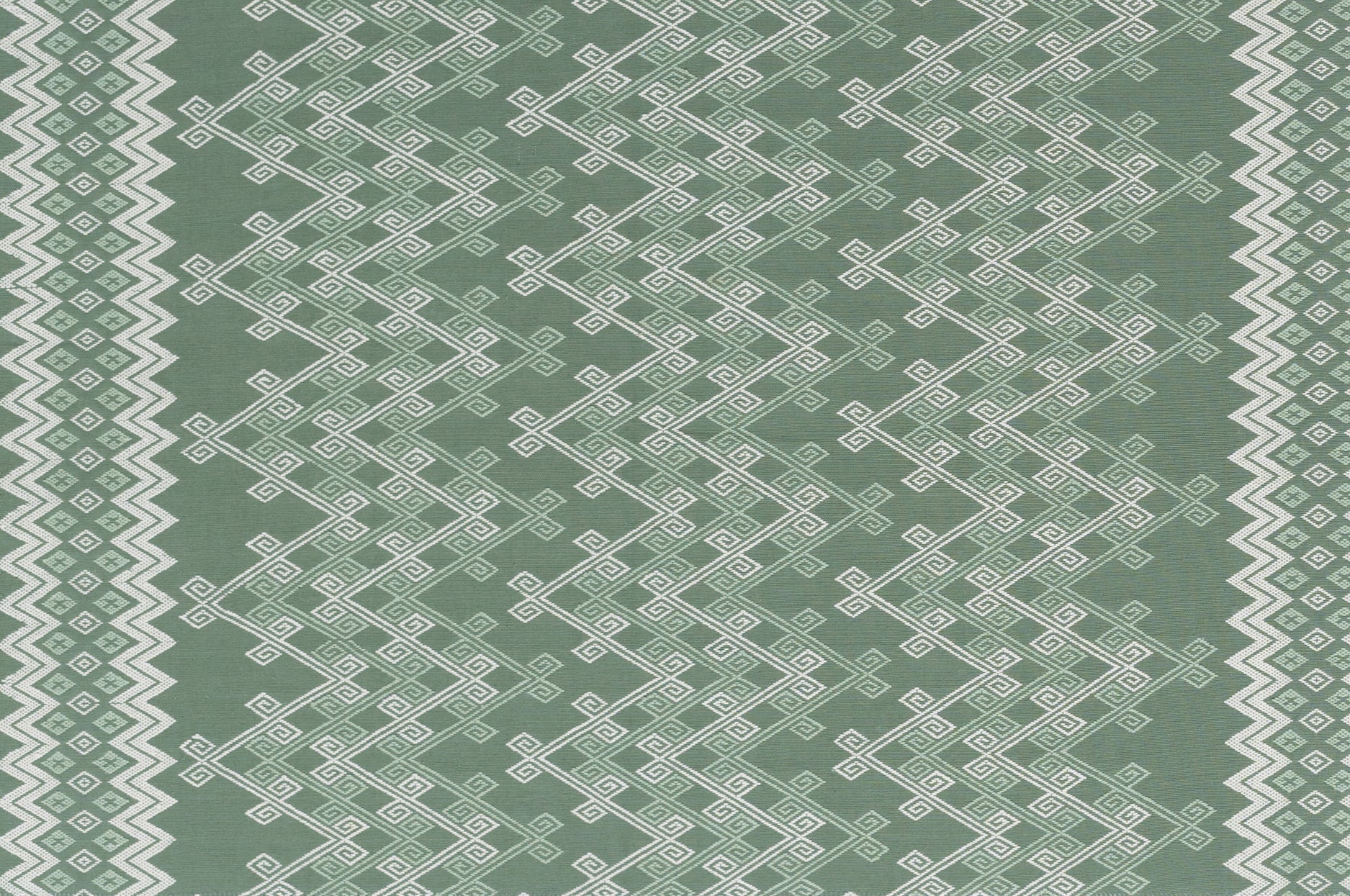 Textile pattern with white geometric design on a green background