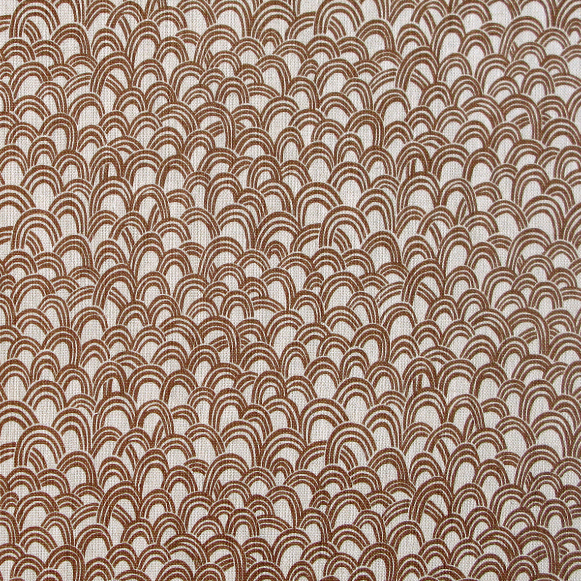 Patterned fabric with a design of curved shapes in brown on a beige background