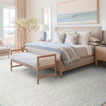 Coastal bedroom setting in blues and beige, with a blue Bellamar area rug.