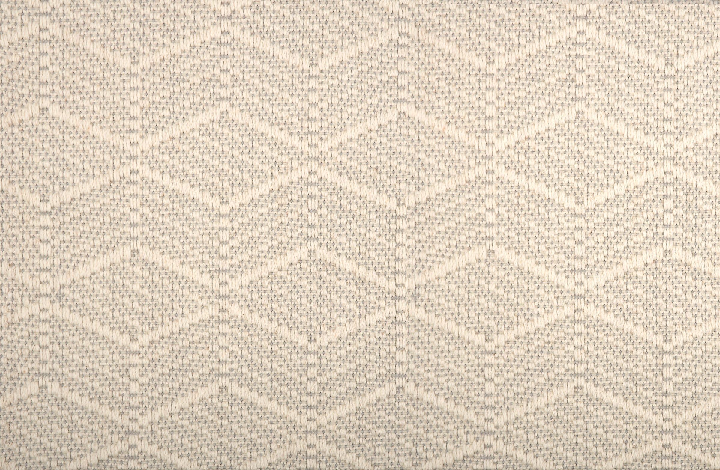 Broadloom in a dimensional herringbone stripe in cream and taupe.