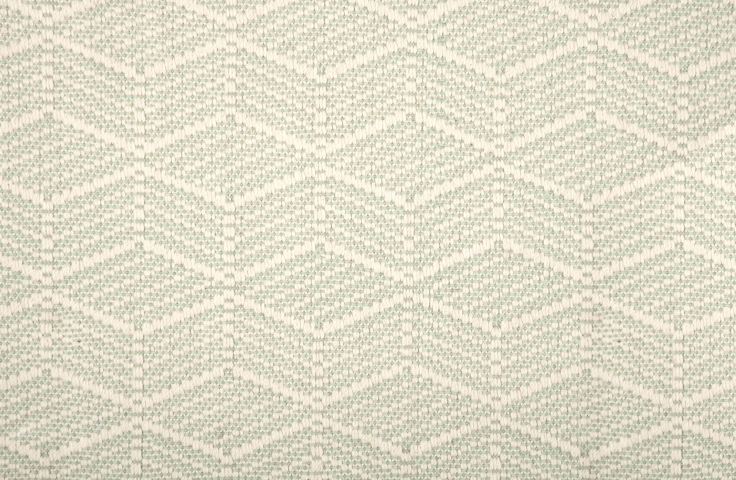 Broadloom in a dimensional herringbone stripe in cream and green.