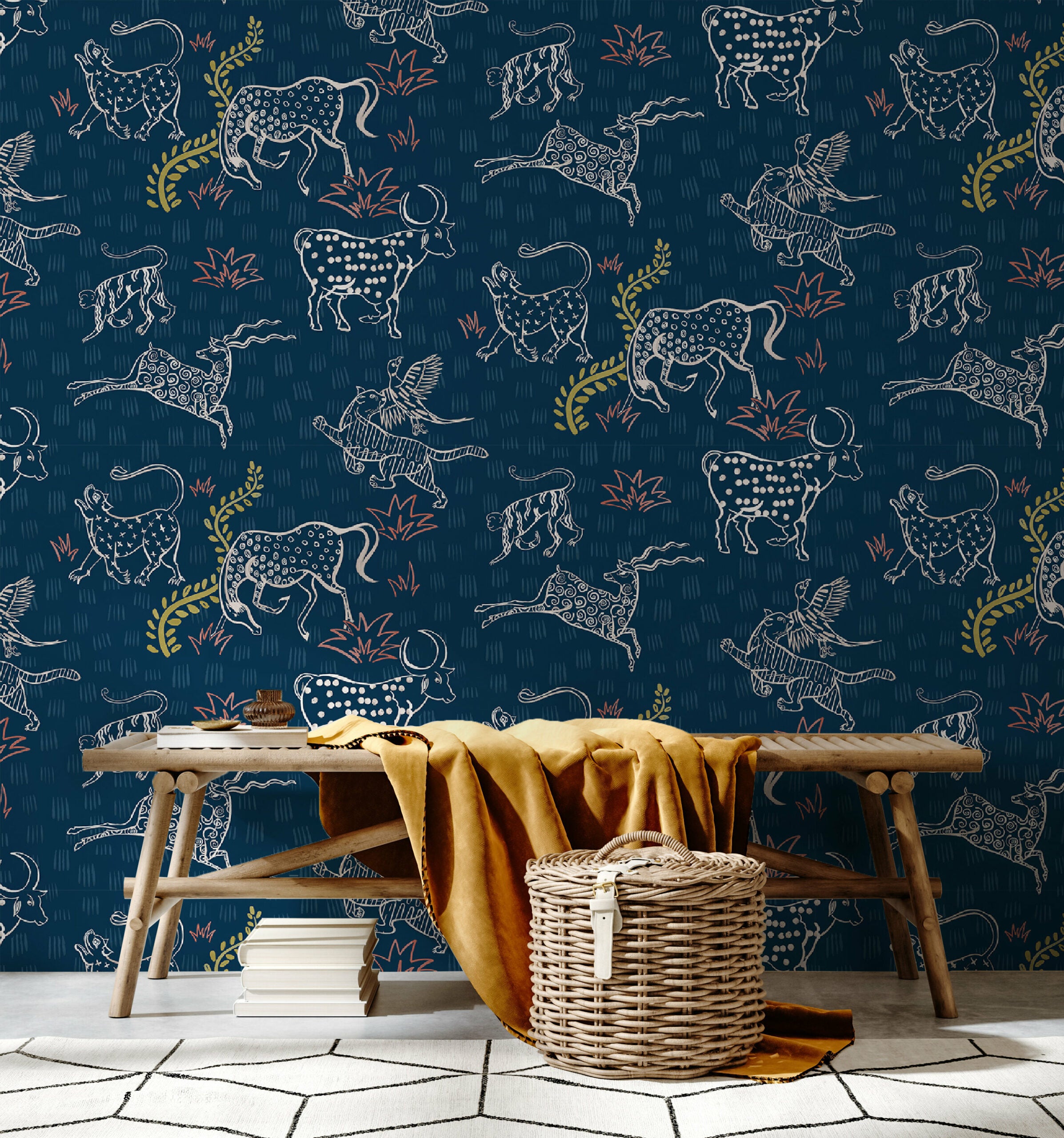 A bench and basket stand in front of a wall papered in a playful hand-drawn animal print in shades of white, pink and navy.