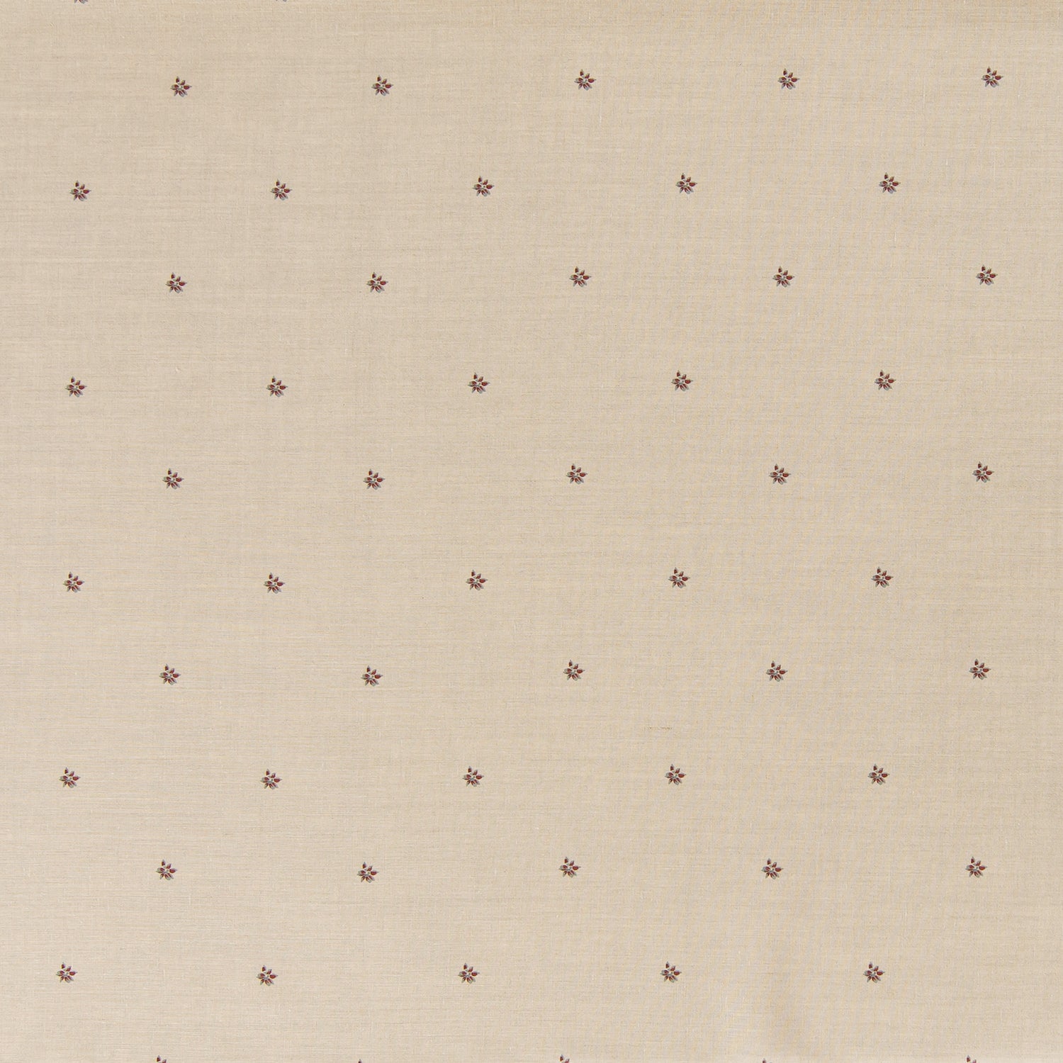 Printed linen fabric in a repeating small-scale flower pattern in red and gray on a cream field.