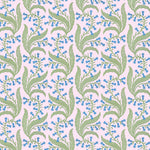 Wallpaper in a scrolling floral pattern in blue and green on a pink field. 