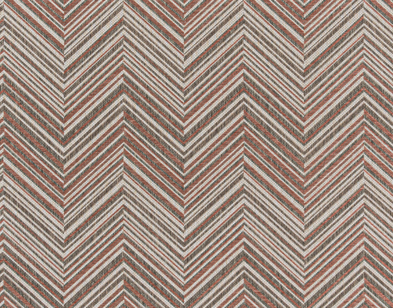Broadloom carpet in a bold chevron pattern in shades of white, brown and rust orange.