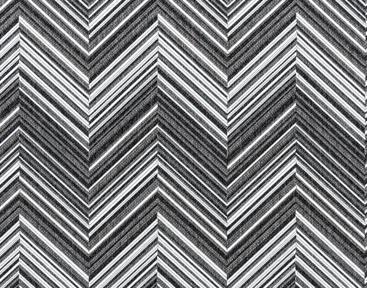 Broadloom carpet in a bold chevron pattern in shades of white, grey and black.