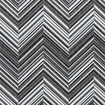 Broadloom carpet in a bold chevron pattern in shades of white, grey and black.