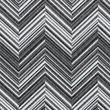 Broadloom carpet in a bold chevron pattern in shades of white, grey and black.