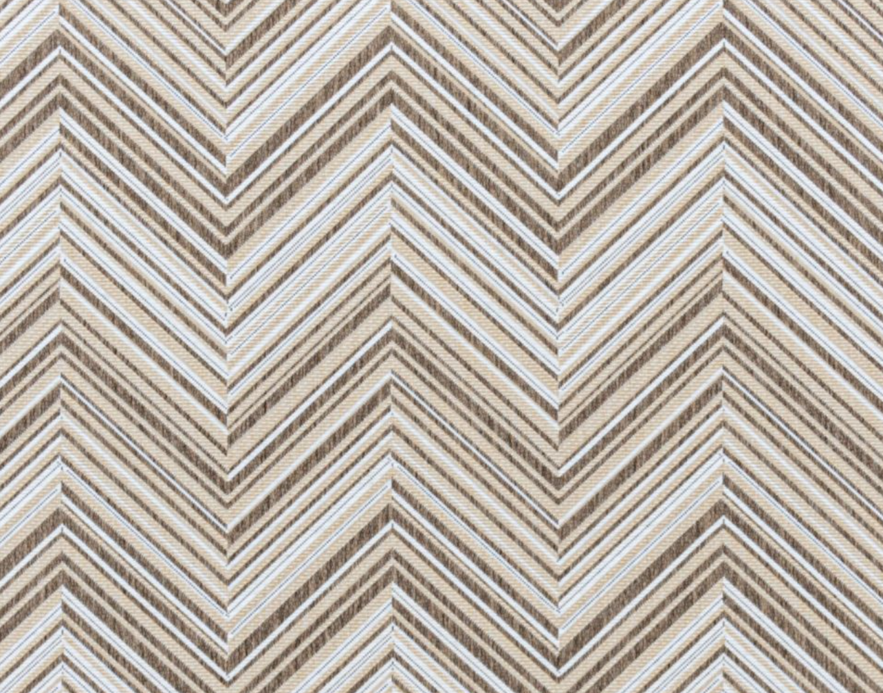 Broadloom carpet in a bold chevron pattern in shades of white, brown and beige.