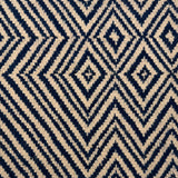 Handwoven rug in tan and navy blue in a diamond stripe design. 
