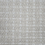 Close-up of a carpet with a textured check pattern in beige and white.