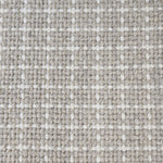 Close-up of a carpet with a textured check pattern in grey and white.