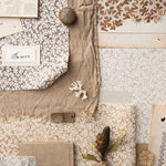 Moodboard image with layered swatches of coral pattern in warm neutral tones and natural specimens. 