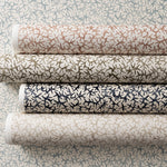 Rolls of wallpaper in watercolor coral design in various colors. 